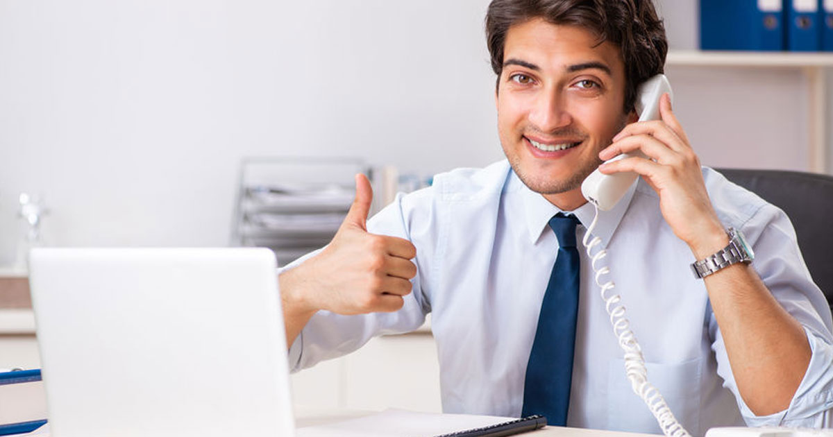Insurance agent smiling while selling insurance over the phone